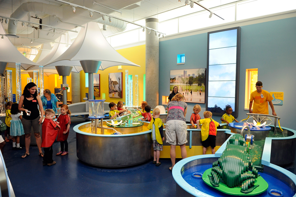 An image of inside the Discovery zone exhibit, where children have a chance to learn and play with a water feature. 