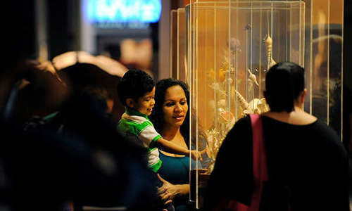 Family looks at an artifact 