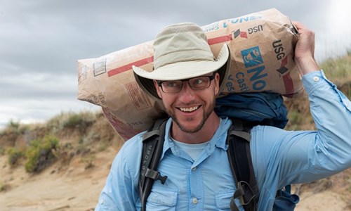 Dr. Tyler Lyson holding a bag of casting material 