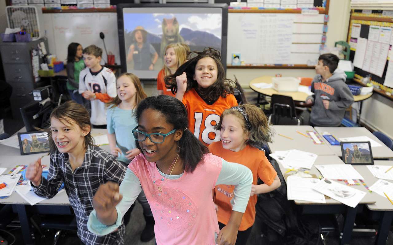 Students "run" from a T. rex during a virtual program.
