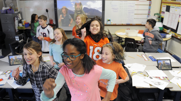 Students "run" from a T. rex during a virtual program.