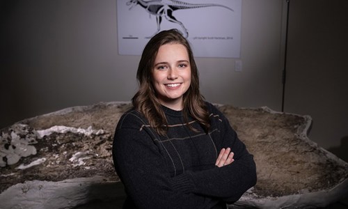 Alex poses in front of the "Teen Rex" specimen