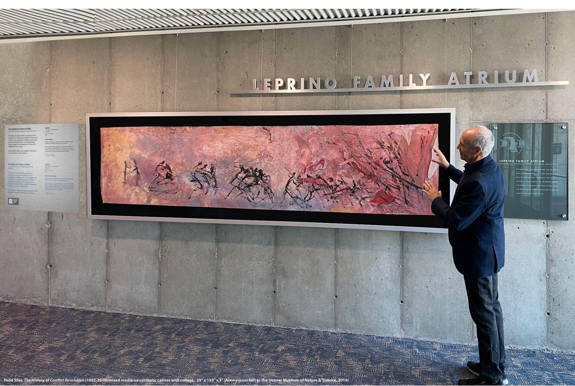 Artist Todd Siler stands beside his painting "The History of Conflict Resolution" in the Denver Museum of Nature & Science's Leprino Family Atrium. (Photo/ DMNS & ISP)