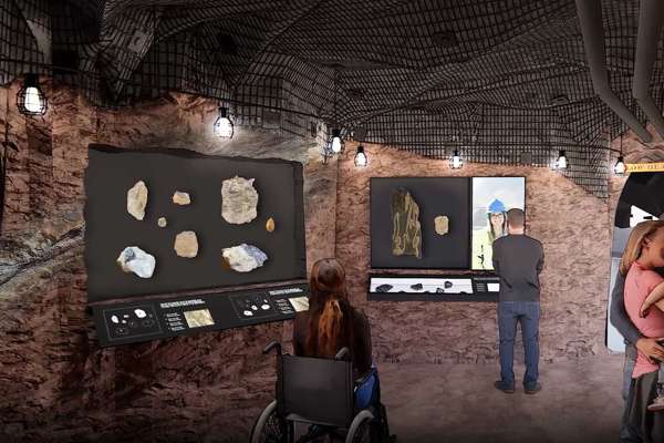 A rendering of the new Gems and Minerals Hall with a man looking at a large topography map