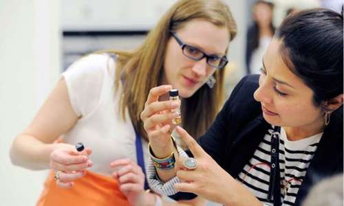 Two people look at a specimen