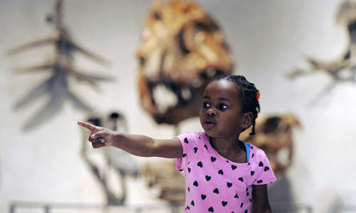 A little girl points into the distance