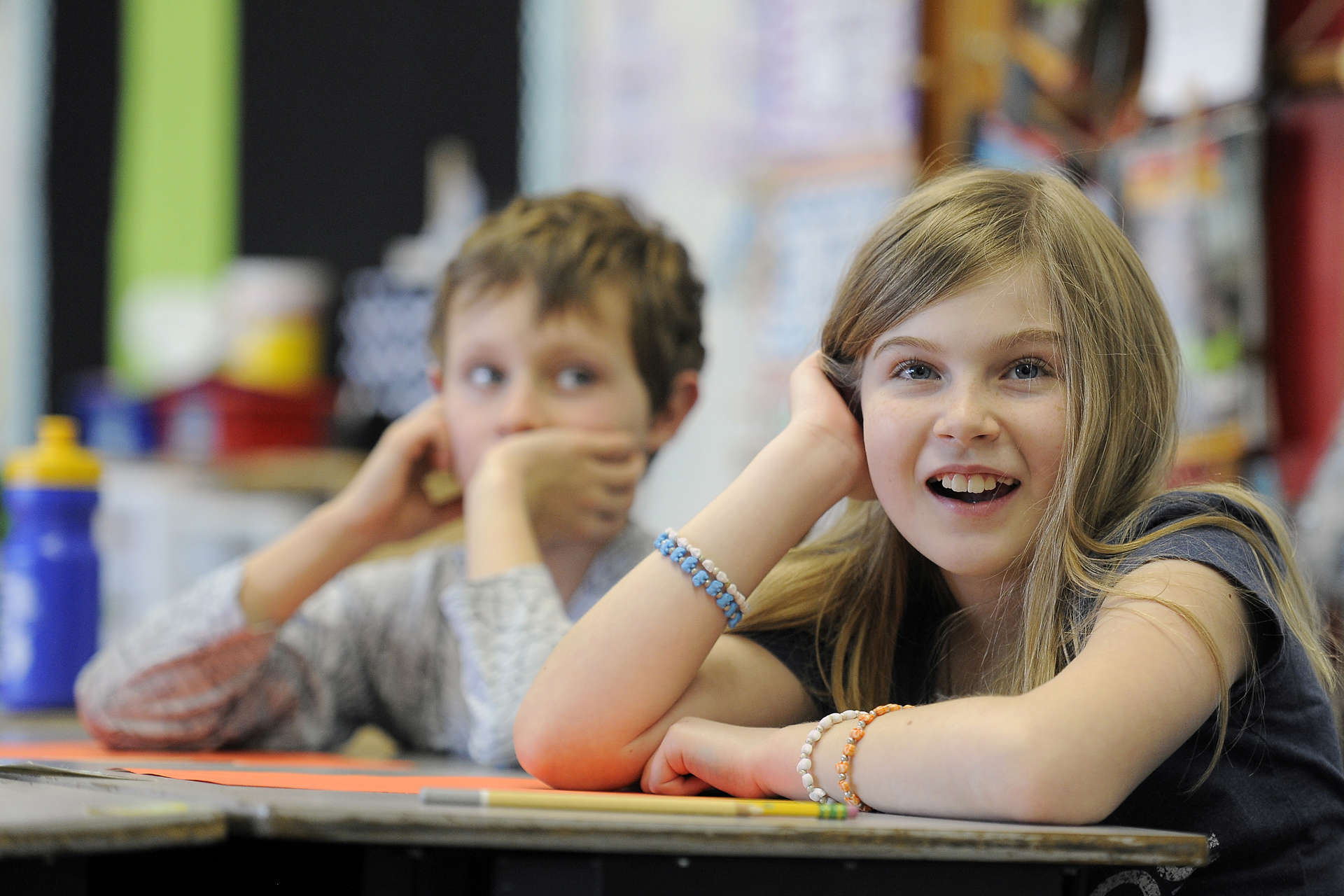 Two students engage with a virtual program from their classroom.