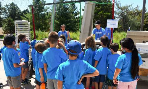 A class of campers meet Teen Science Scholars presenting their summer research findings